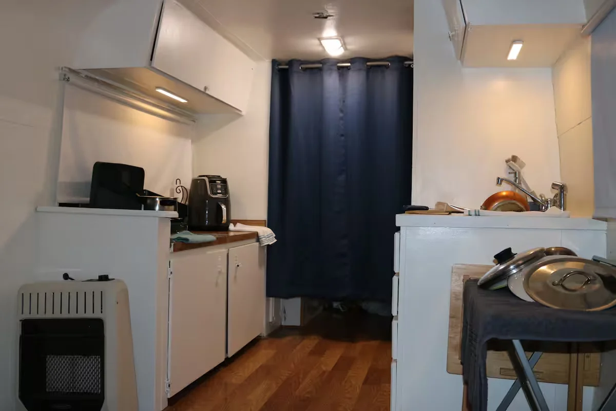 The Avion kitchen with white cabinets, countertop appliances, and a sink